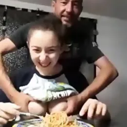 Perverted father dips his daughter's big natural tits in spaghetti while she eats them
